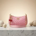 Chic Pink Coach Handbag with Cherry Charms - Image 2