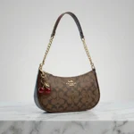 Elegant Coach Brown Monogram Bag with Cherry Charms