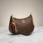 Elegant Coach Brown Monogram Bag with Cherry Charms - Image 2