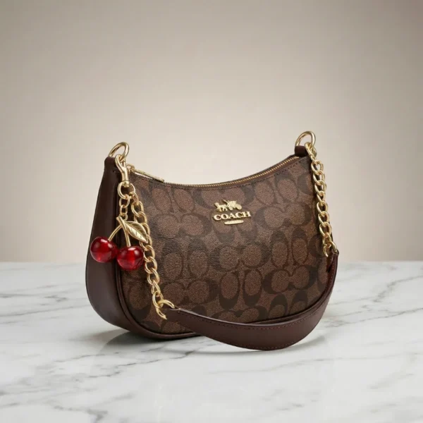 Elegant Coach Brown Monogram Bag with Cherry Charms - Image 2