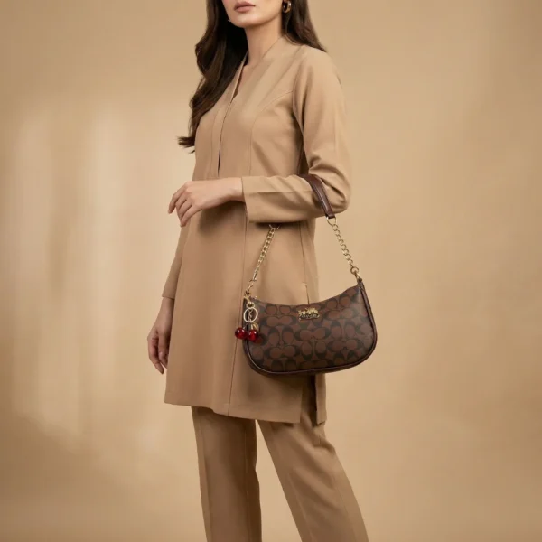 Elegant Coach Brown Monogram Bag with Cherry Charms - Image 3